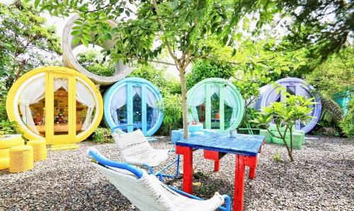 a group of playhouses and a table and chairs at 與大自然融合的包棟小屋 in Hengchun