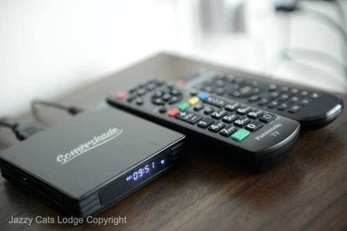 two remote controls sitting on top of a table at 3BR Jazz Suites Vivacity Megamall Kuching Sarawak in Kuching