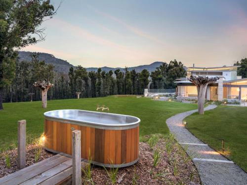 a bath tub in the middle of a yard at Robinsons Run The ultimate luxury country retreat in Kangaroo Valley