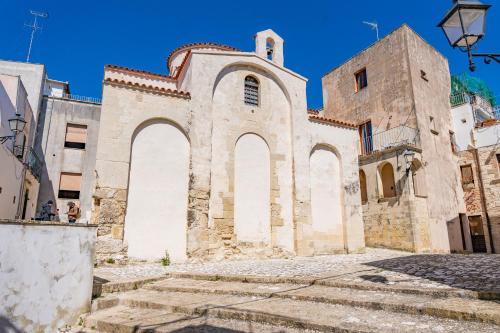 an old church with stairs in front of it at Leondari Rooms V Collection Otranto in Otranto