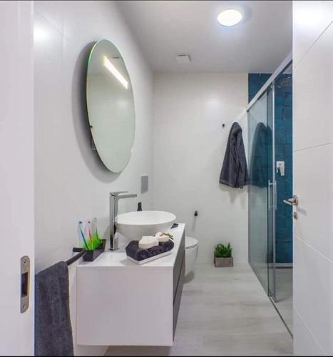 a white bathroom with a sink and a mirror at Le petit nid de Xanie in Orihuela Costa