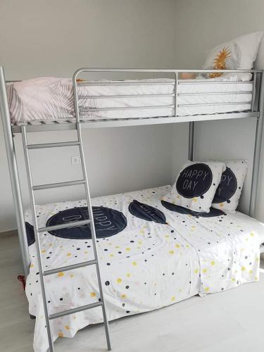 a bedroom with a bunk bed and a ladder at Le petit nid de Xanie in Orihuela Costa