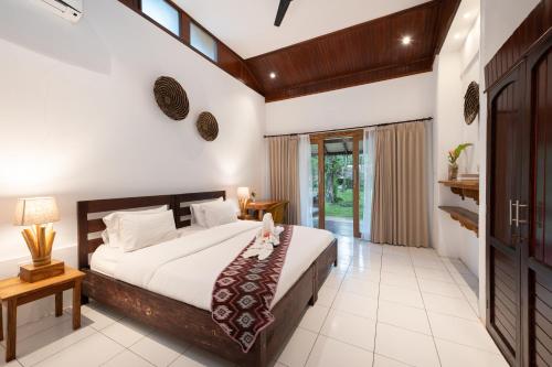En eller flere senger på et rom på Murex Dive Resort