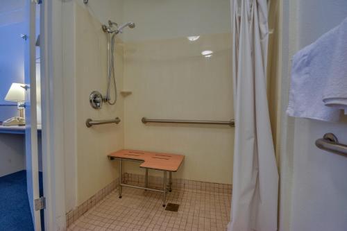 La salle de bains est pourvue d'une douche et d'une table en bois. dans l'établissement Motel 6-Birmingham, AL, à Birmingham