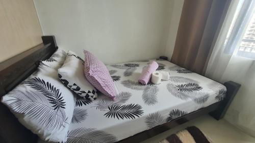 a small bed with pillows on it in a room at Sea Residences EZBedz in Manila