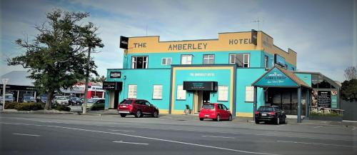 a blue building with cars parked in front of it at The Amberley Hotel in Amberley