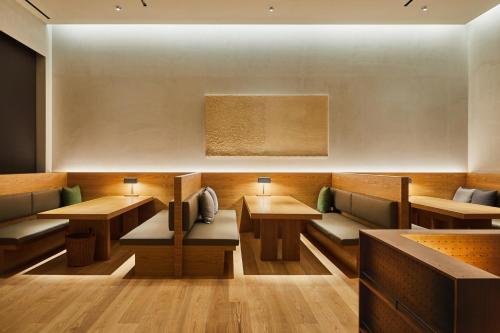 a restaurant with wooden tables and couches in a room at Phoenix Resort Pyeongchang in Pyeongchang 