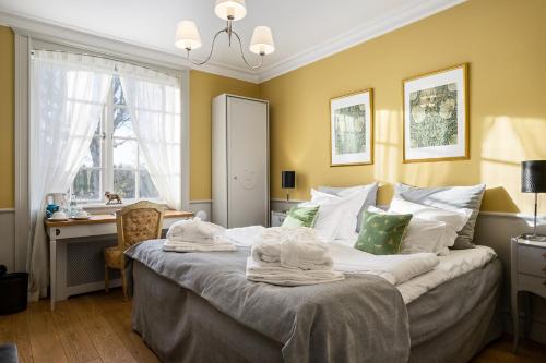 a bedroom with a bed with towels on it at Häringe Slott in Västerhaninge