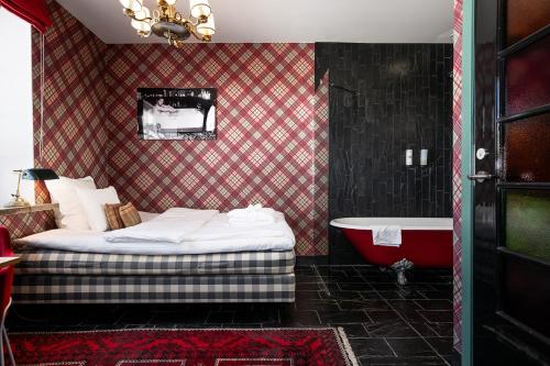 a bedroom with a bed and a bath tub at Häringe Slott in Västerhaninge