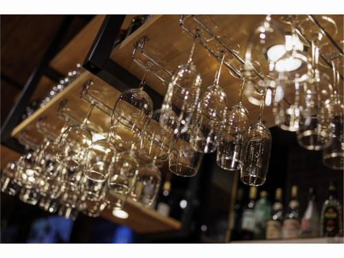 a bunch of wine glasses hanging from a chandelier at Place Hotel Ascot in Kumamoto