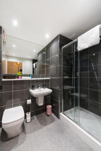 a bathroom with a toilet and a sink and a shower at 48 Annandale Street in Edinburgh