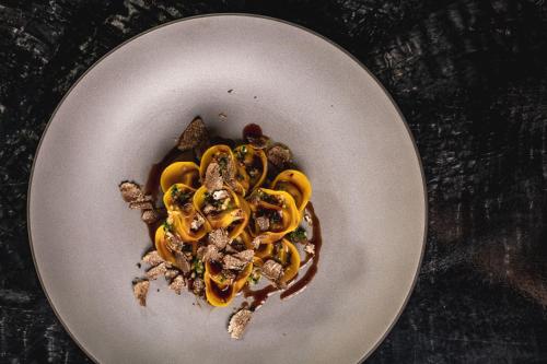 a plate of food on a table with food on it at Alpin Garden Luxury Maison & SPA - Adults Only in Ortisei