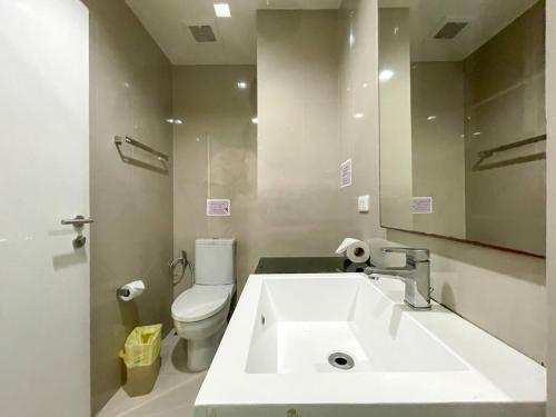 a bathroom with a sink and a toilet and a mirror at The Deck Patong studio 155 by AM in Patong Beach