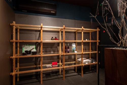a wooden shelf with items on it in a room at Ryokan Nushiya in Gotsu