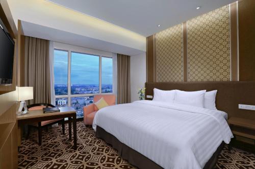 Ένα ή περισσότερα κρεβάτια σε δωμάτιο στο Atria Hotel Gading Serpong