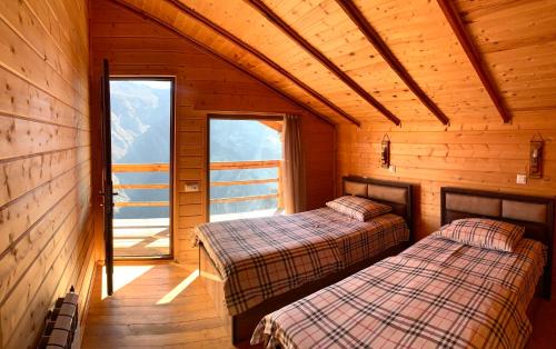 a room with two beds in a wooden cabin at Harsnadzor Eco Resort in Halidzor