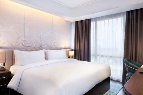 Ένα ή περισσότερα κρεβάτια σε δωμάτιο στο Atria Hotel Gading Serpong