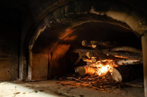 a brick oven with a fire in it at Locanda Genzianella in Gargnano