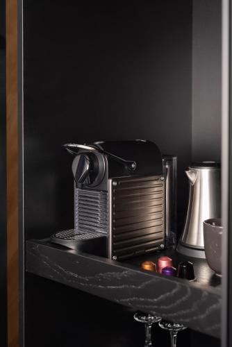 a toaster oven sitting on a shelf in a kitchen at Hotel VEGA Sofia in Sofia