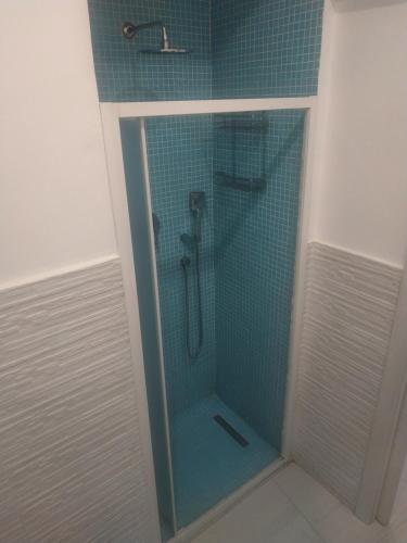 a shower with a glass door in a bathroom at Casa in borgo marinaro in Giardini Naxos