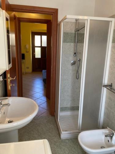 a bathroom with a shower and a sink and a toilet at Residenza Graziella in Bobbio Pellice