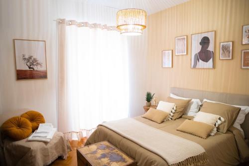 a bedroom with a large bed and a window at Quisì - Salerno Centro in Salerno