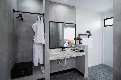 a bathroom with a sink and a mirror at Kampot Sweet Boutique in Kampot