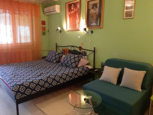a bedroom with a bed and a couch at Apartment Adela in Požarevac
