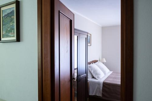 a door leading to a bedroom with a bed at Locanda Genzianella in Gargnano