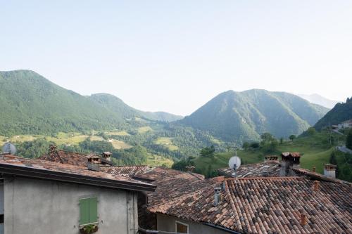 a group of houses with mountains in the background at Locanda Genzianella in Gargnano