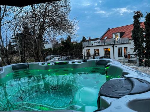 a swimming pool covered in snow in front of a house at Patent, your home in Badacsony in Badacsonytomaj