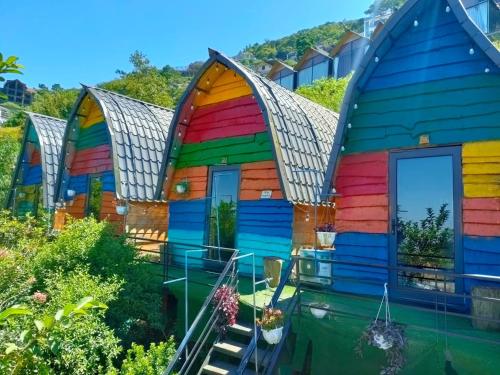 a group of houses painted in different colors at Sa Mộc House Tam Đảo - Venuestay in Vĩnh Phúc