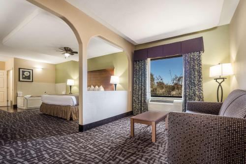 a hotel room with a bed and a window at SureStay Hotel by Best Western Alice in Alice