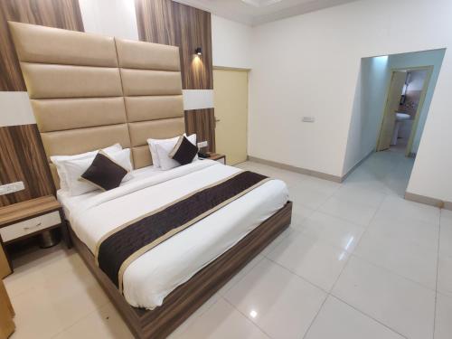 a bedroom with a large bed in a room at Raj Darbar - 10 Meter From Golden Temple in Amritsar