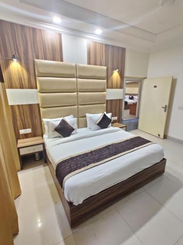 a bedroom with a large bed in a room at Raj Darbar - 10 Meter From Golden Temple in Amritsar