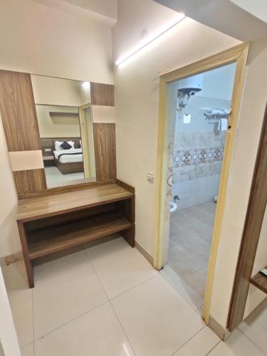 a bathroom with a mirror and a sink in a room at Raj Darbar - 10 Meter From Golden Temple in Amritsar