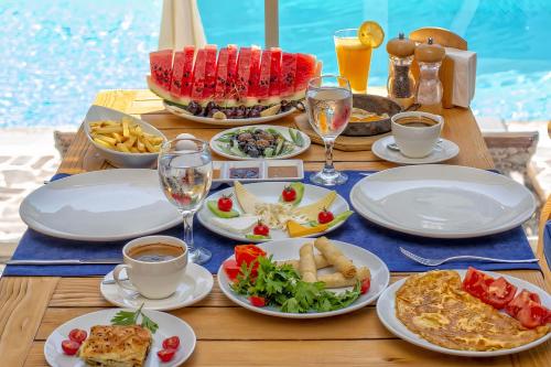 a table with plates of food on a table by a pool at Side Beach Club in Side
