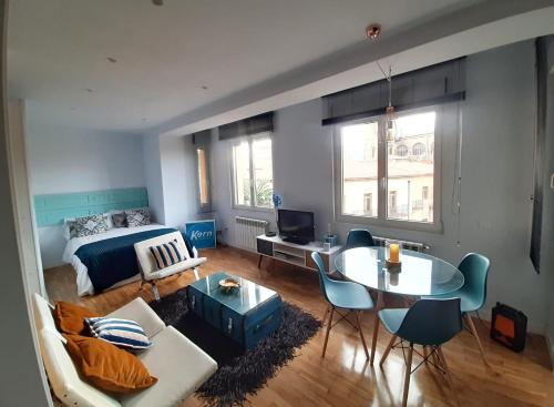 a living room with a couch and a table at Apartamento Wamba - La Catedral in Oviedo