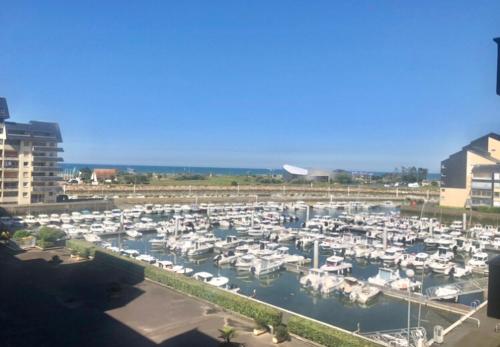 a bunch of boats parked in a marina at Les Sardines in Courseulles-sur-Mer