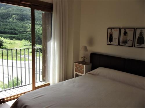a bedroom with a bed and a large window at Mirador Gavin in Gavín