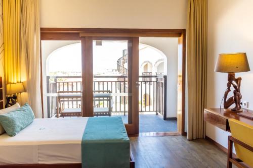 a bedroom with a bed and a balcony at Hotel Odjo d'água in Santa Maria