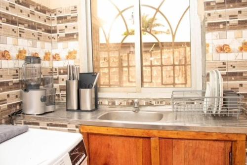 a kitchen with a sink and a window at Fully air-condition 3Bed Villa - WiFi - hot water in Freetown