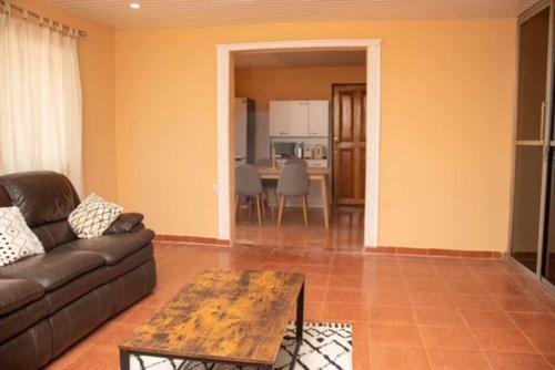 a living room with a couch and a table at Full AirCon- 3Bed Villa- A c- WiFi- HotWater in Freetown
