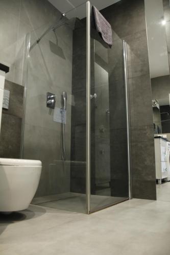 a shower with a glass door in a bathroom at APARTAMENT TETRIS - CENTRUM in Kielce