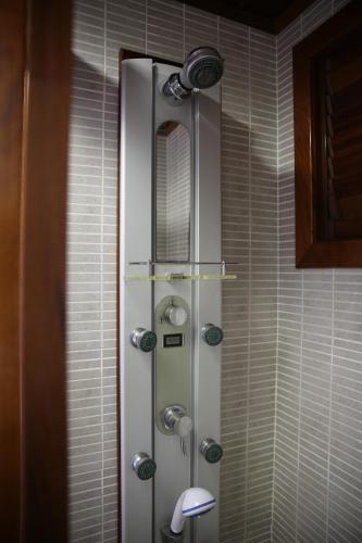 a shower in a bathroom with a mirror at Apartamentos Mar y Sal in La Savina
