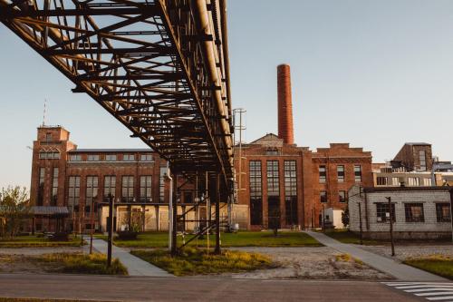 a bridge over a street in front of a factory at Cukrownia Żnin in Żnin