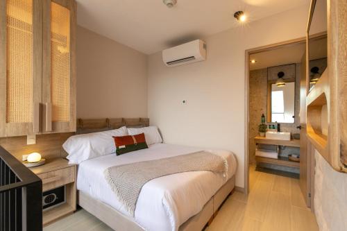 a small bedroom with a bed and a bathroom at Landmark Hotel in Medellín