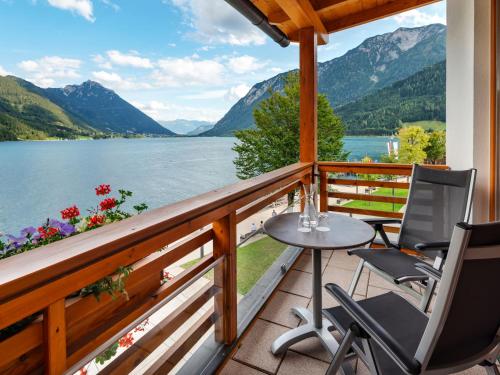 a balcony with a view of a lake and mountains at aja Fürstenhaus am Achensee in Pertisau