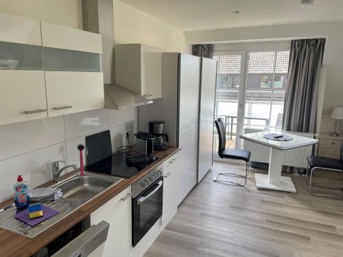 a kitchen with a sink and a stove top oven at Seaside-Amrum-10 in Norddorf