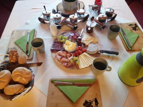 a table topped with a table with food and drinks at Pension Arkadenhof in Loipersdorf bei Fürstenfeld